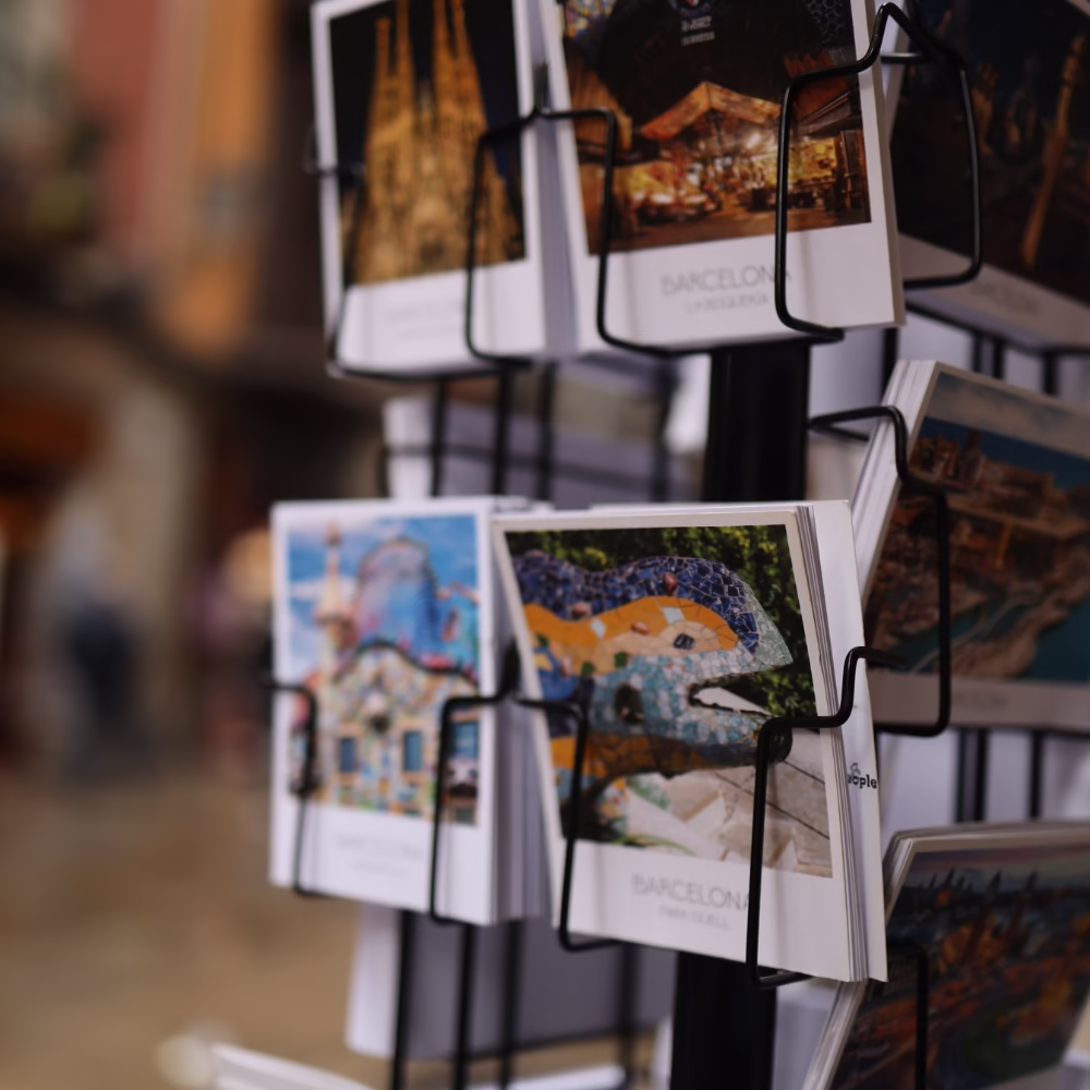 Rack of colorful Barcelona postcards.